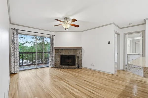 wooden floor fireplace and natural light in room