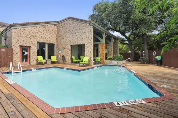 a view of a house with pool and chairs