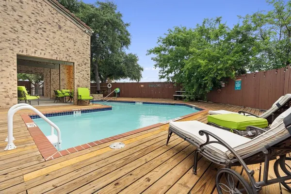 swimming pool with outdoor seating and yard