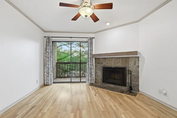 wooden floor fireplace and windows in an empty room
