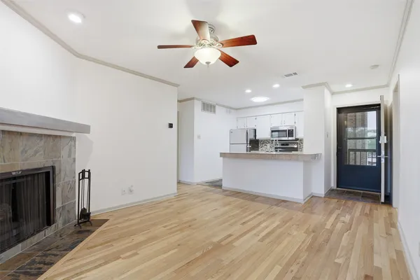 a view of kitchen with refrigerator and microwave