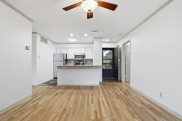 a kitchen with a refrigerator and window