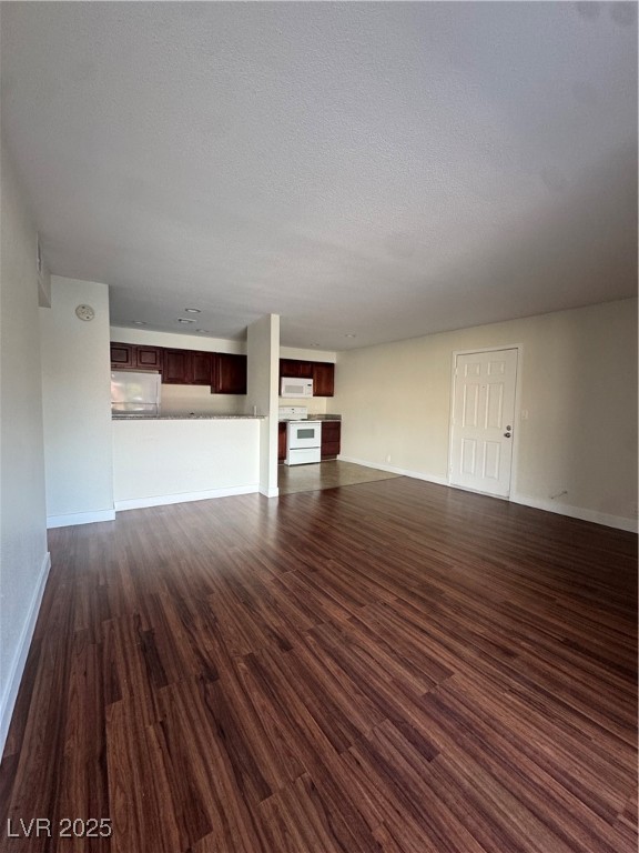 5188 River Glen Drive, Unit 458 Las Vegas, NV 89103 - Photo 12 of 13 Unfurnished living room with dark wood-type flooring and a textured ceiling
