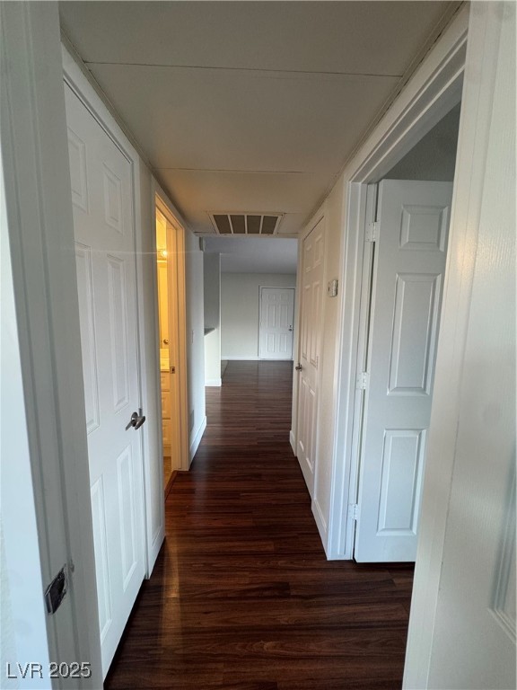 5188 River Glen Drive, Unit 458 Las Vegas, NV 89103 - Photo 8 of 13 Hallway featuring dark wood-type flooring and baseboards