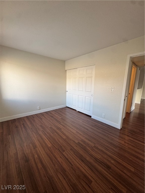 5188 River Glen Drive, Unit 458 Las Vegas, NV 89103 - Photo 9 of 13 Unfurnished bedroom featuring dark wood finished floors and a closet