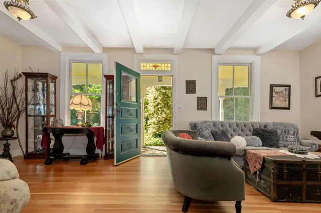 a bedroom with furniture and a mirror