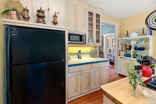 a living room with furniture a lamp and a potted plant