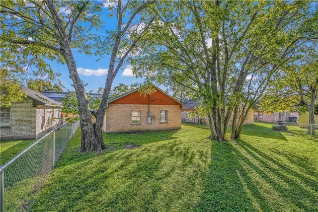 a yellow house in middle of the forest
