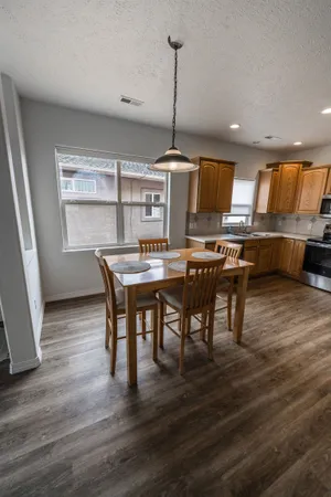 a view of a dining room with furniture window and wooden floor