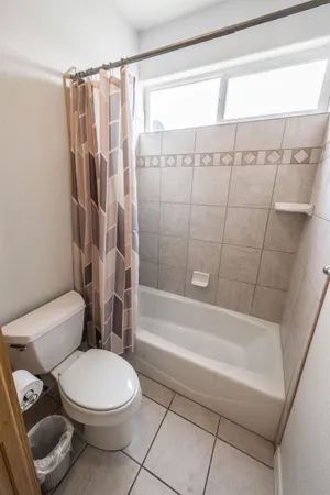 a bathroom with a toilet and a shower