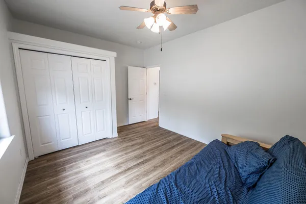 a bedroom with a bed and a chandelier