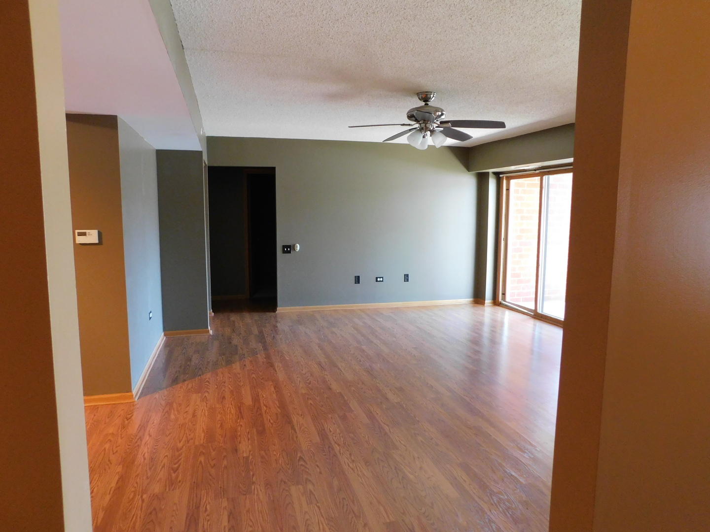 18100 Rita Road, Unit 1B Tinley Park, IL 60477 - Photo 3 of 24 wooden floor in an empty room with a window