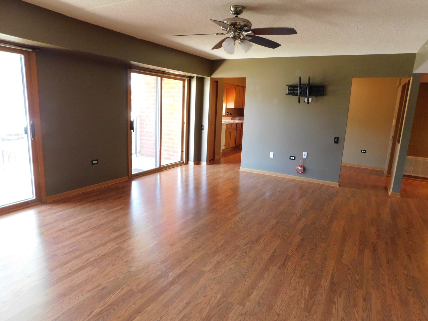 18100 Rita Road, Unit 1B Tinley Park, IL 60477 - Photo 4 of 24 an empty room with wooden floor and windows