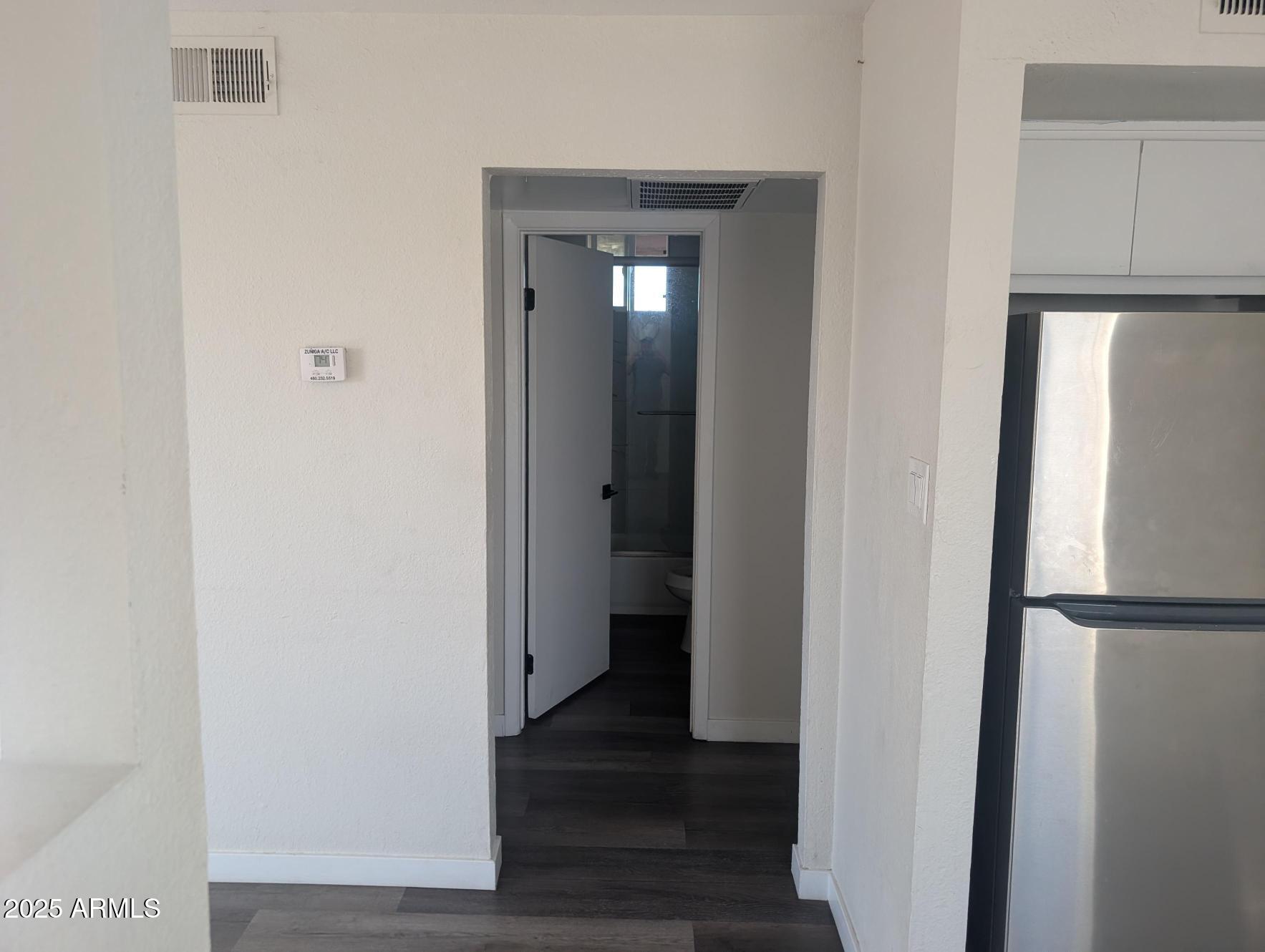 7160 North 53rd Avenue, Unit 2 Glendale, AZ 85301 - Photo 11 of 20 a view of a hallway with wooden floor and closet