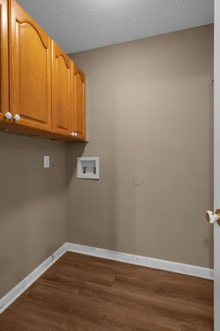 a view of an empty room and wooden floor