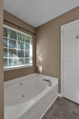 a white bath tub sitting next to a window