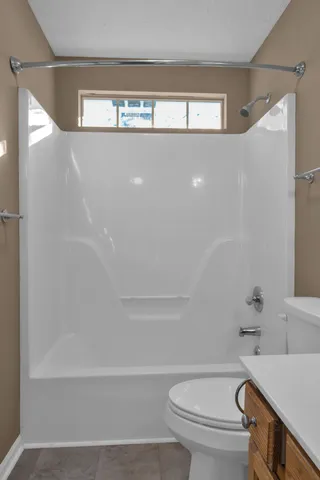 a bathroom with a bathtub and a toilet