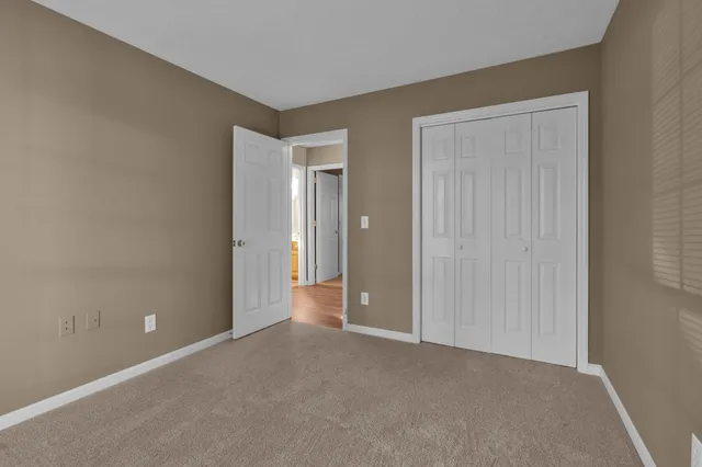 a view of an empty room with closet area