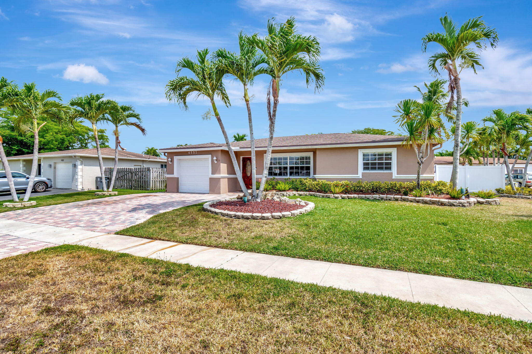 4557 Avalon Street Boca Raton, FL 33428 - Photo 1 of 47 a view of a house with a yard and potted plants