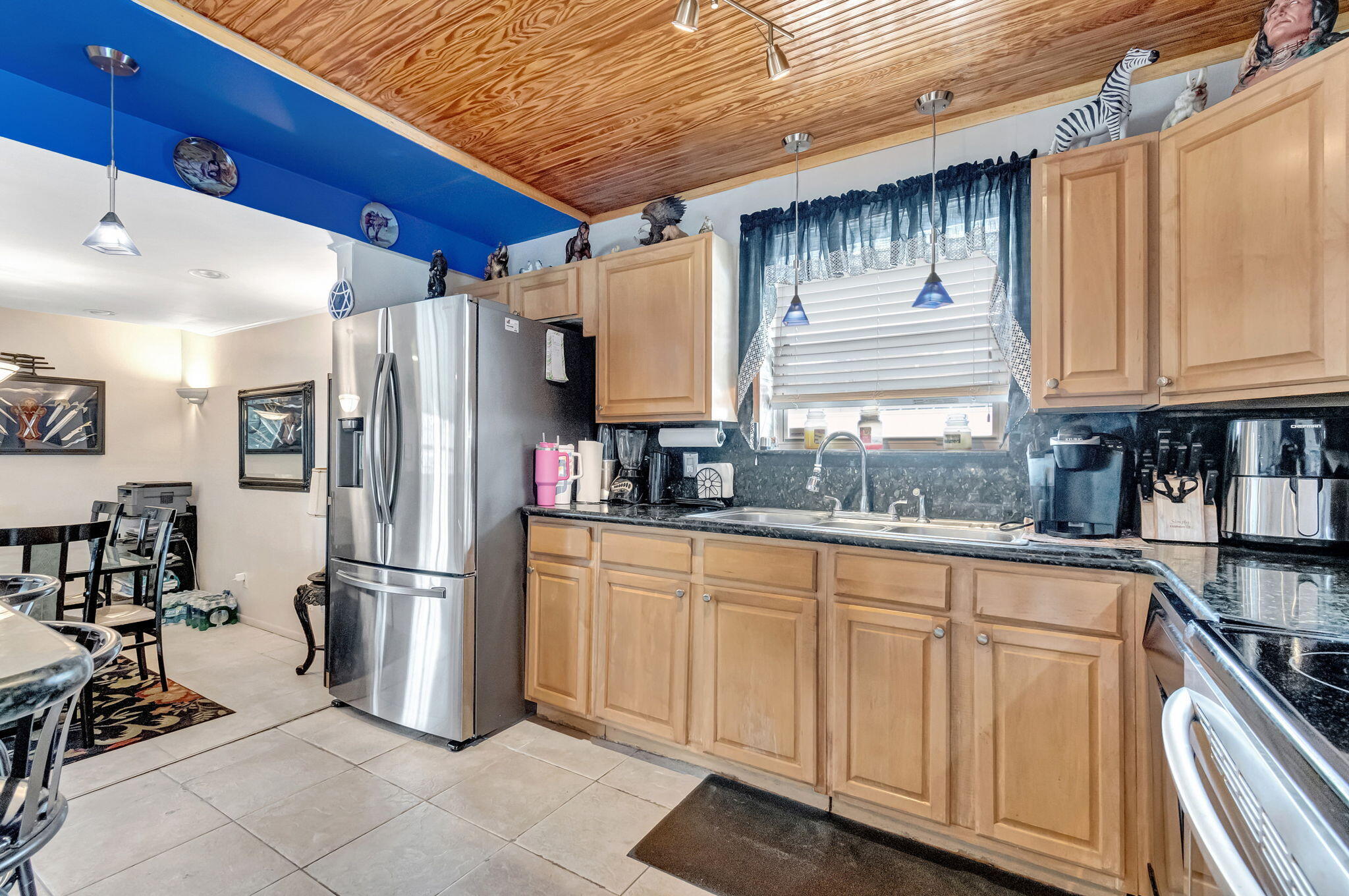 4557 Avalon Street Boca Raton, FL 33428 - Photo 16 of 47 a kitchen with refrigerator and cabinets