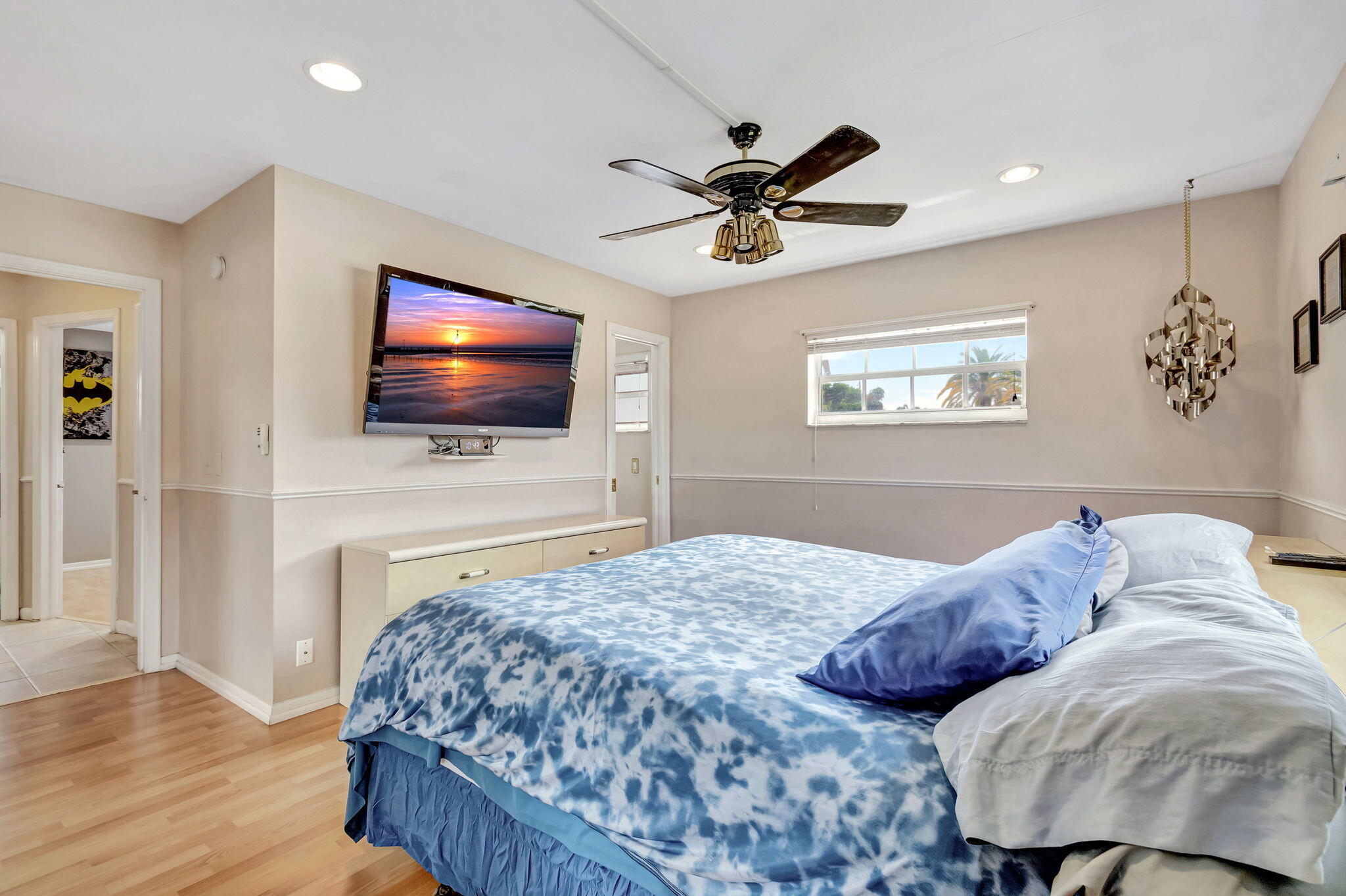 4557 Avalon Street Boca Raton, FL 33428 - Photo 20 of 47 a bedroom with a bed a flat screen tv and a couch