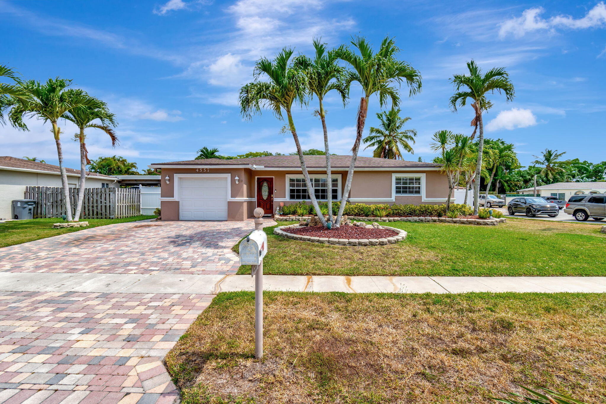 4557 Avalon Street Boca Raton, FL 33428 - Photo 2 of 47 a front view of a house with garden