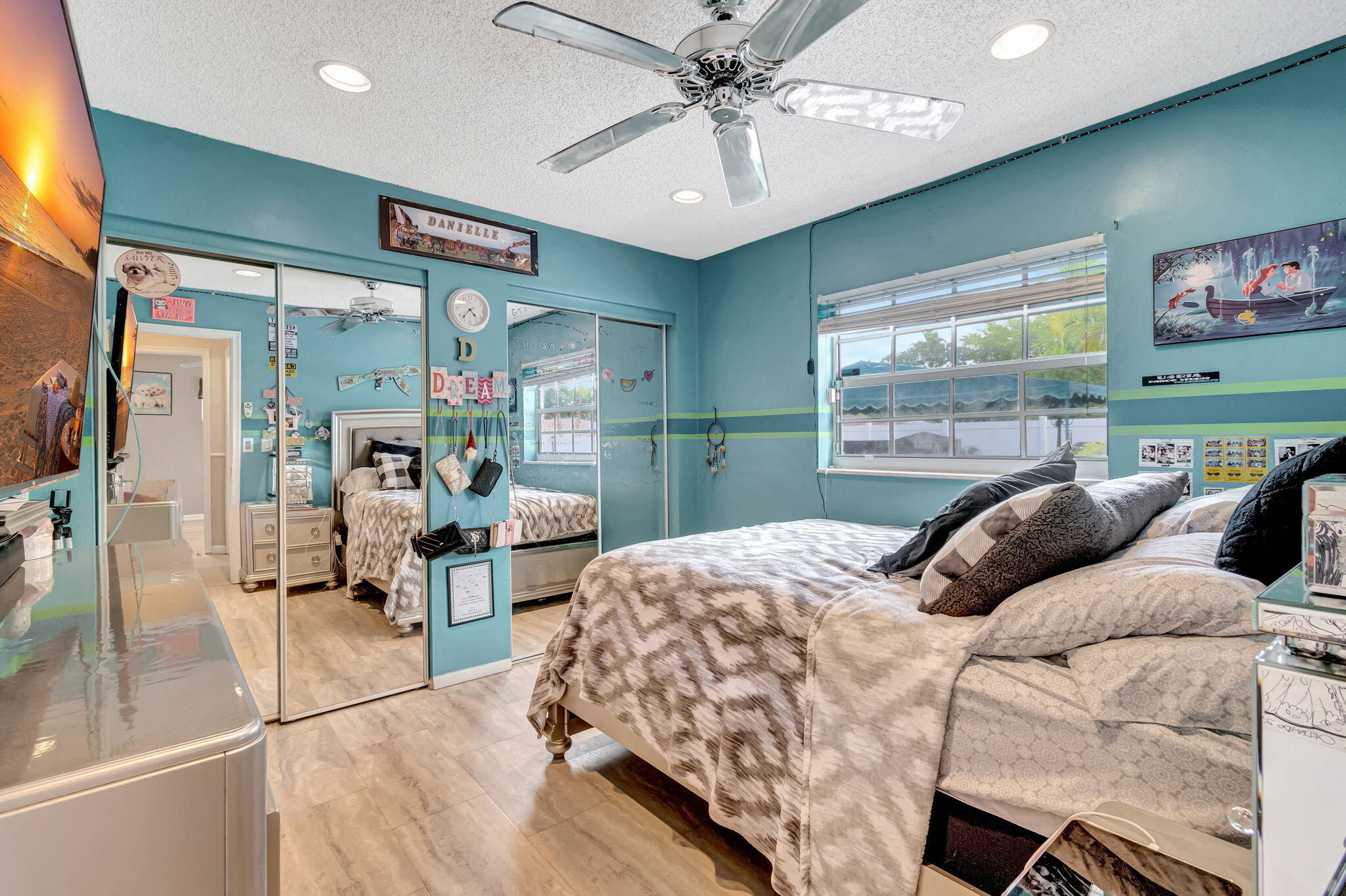 4557 Avalon Street Boca Raton, FL 33428 - Photo 29 of 47 a bedroom with a large bed and a chandelier