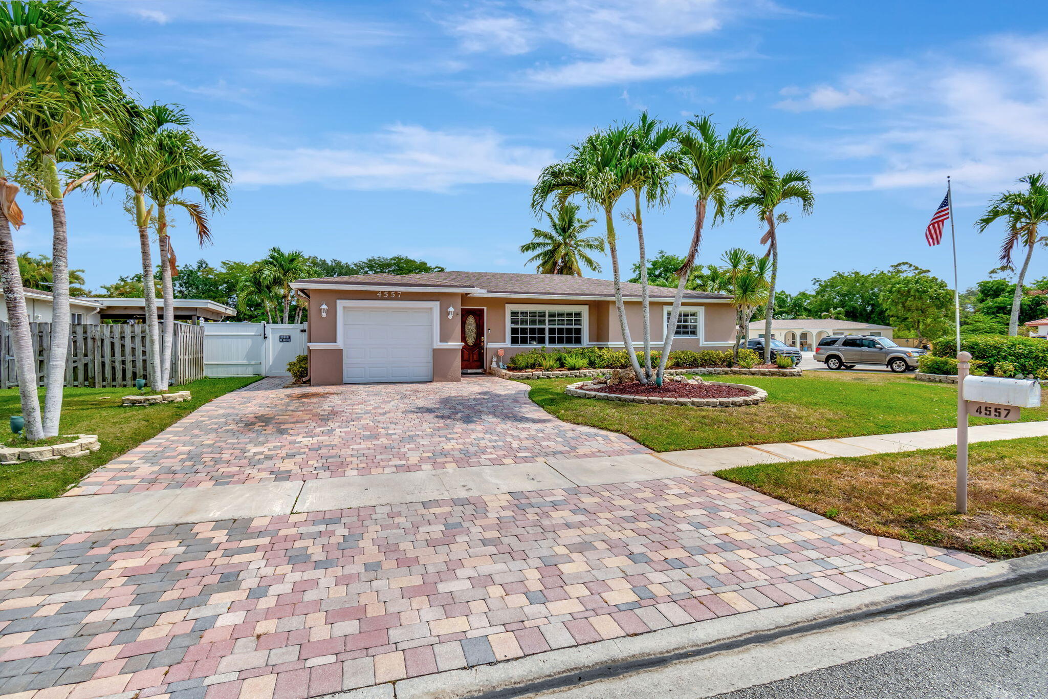 4557 Avalon Street Boca Raton, FL 33428 - Photo 3 of 47 a front view of a house with garden