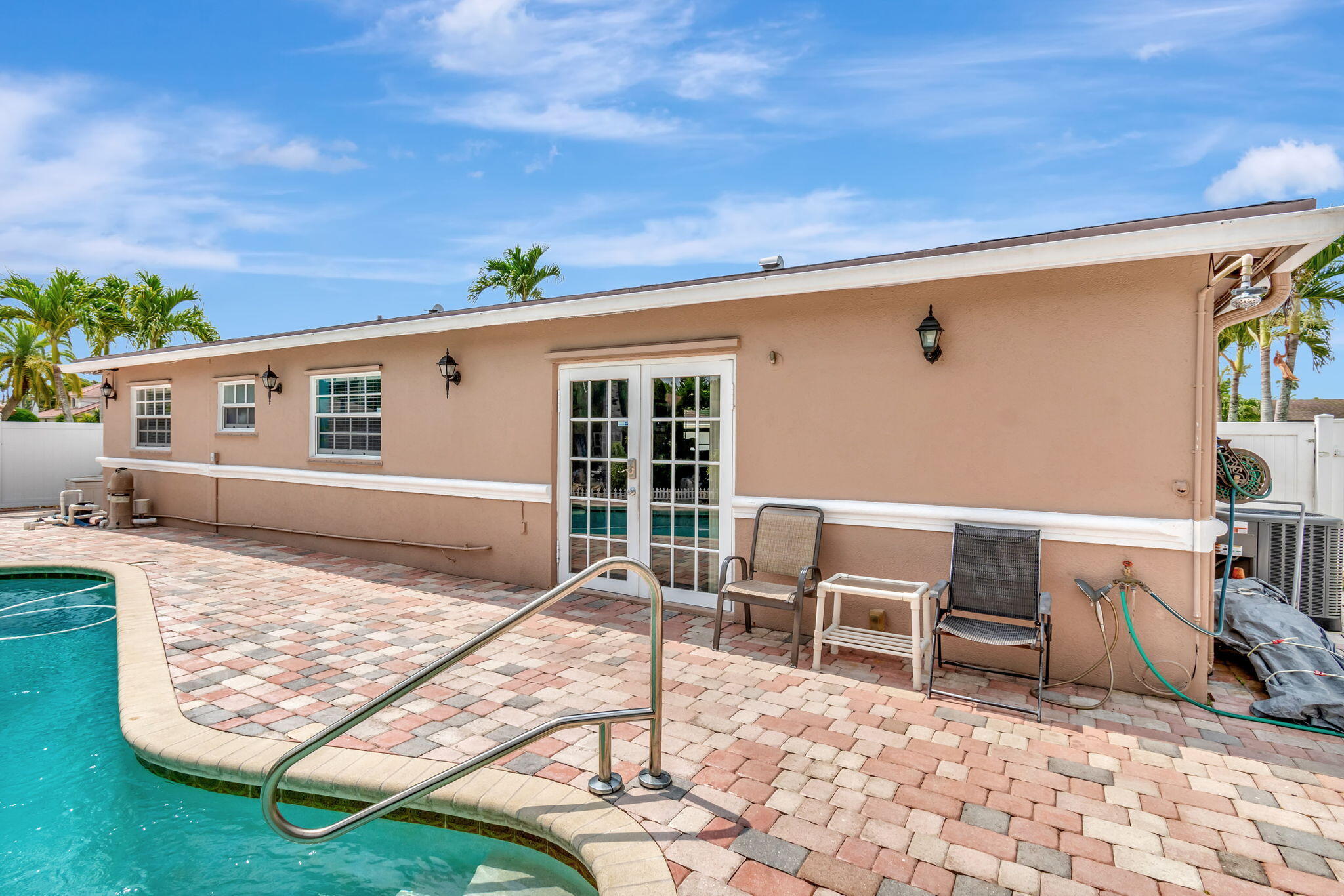 4557 Avalon Street Boca Raton, FL 33428 - Photo 46 of 47 a view of a patio with table and chairs with wooden fence
