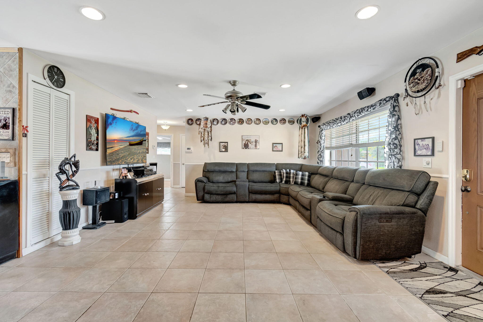 4557 Avalon Street Boca Raton, FL 33428 - Photo 7 of 47 a living room with furniture and a flat screen tv
