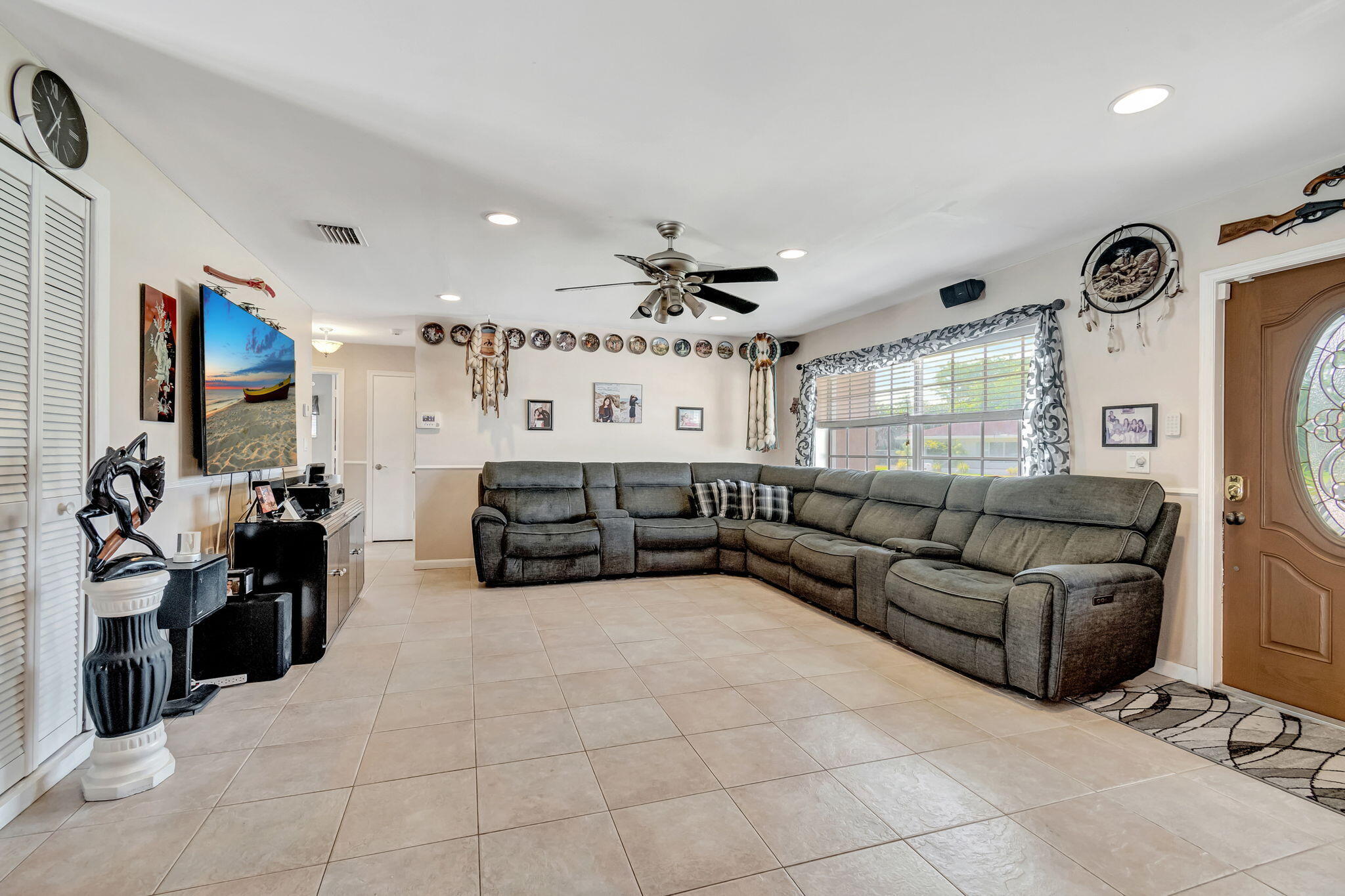 4557 Avalon Street Boca Raton, FL 33428 - Photo 8 of 47 a large living room with furniture and a large window