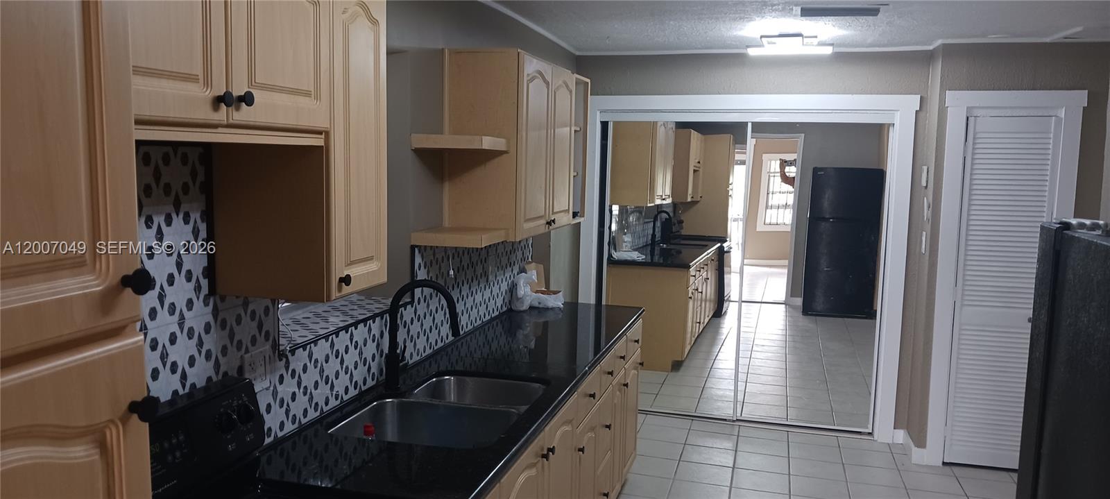 2272 Southwest 8th Street, Unit 3 Miami, FL 33135 - Photo 12 of 23 a hallway with dining area and chandelier