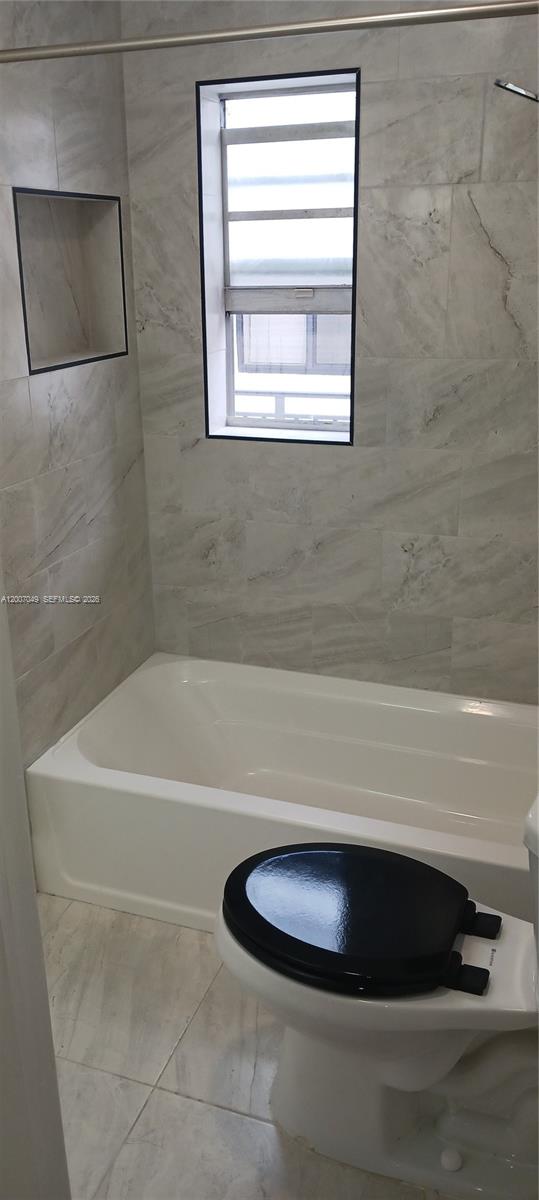 2272 Southwest 8th Street, Unit 3 Miami, FL 33135 - Photo 17 of 23 a bathroom with a bathtub