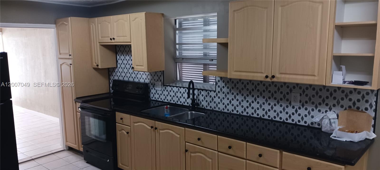 2272 Southwest 8th Street, Unit 3 Miami, FL 33135 - Photo 10 of 23 a kitchen with granite countertop a sink and a stove