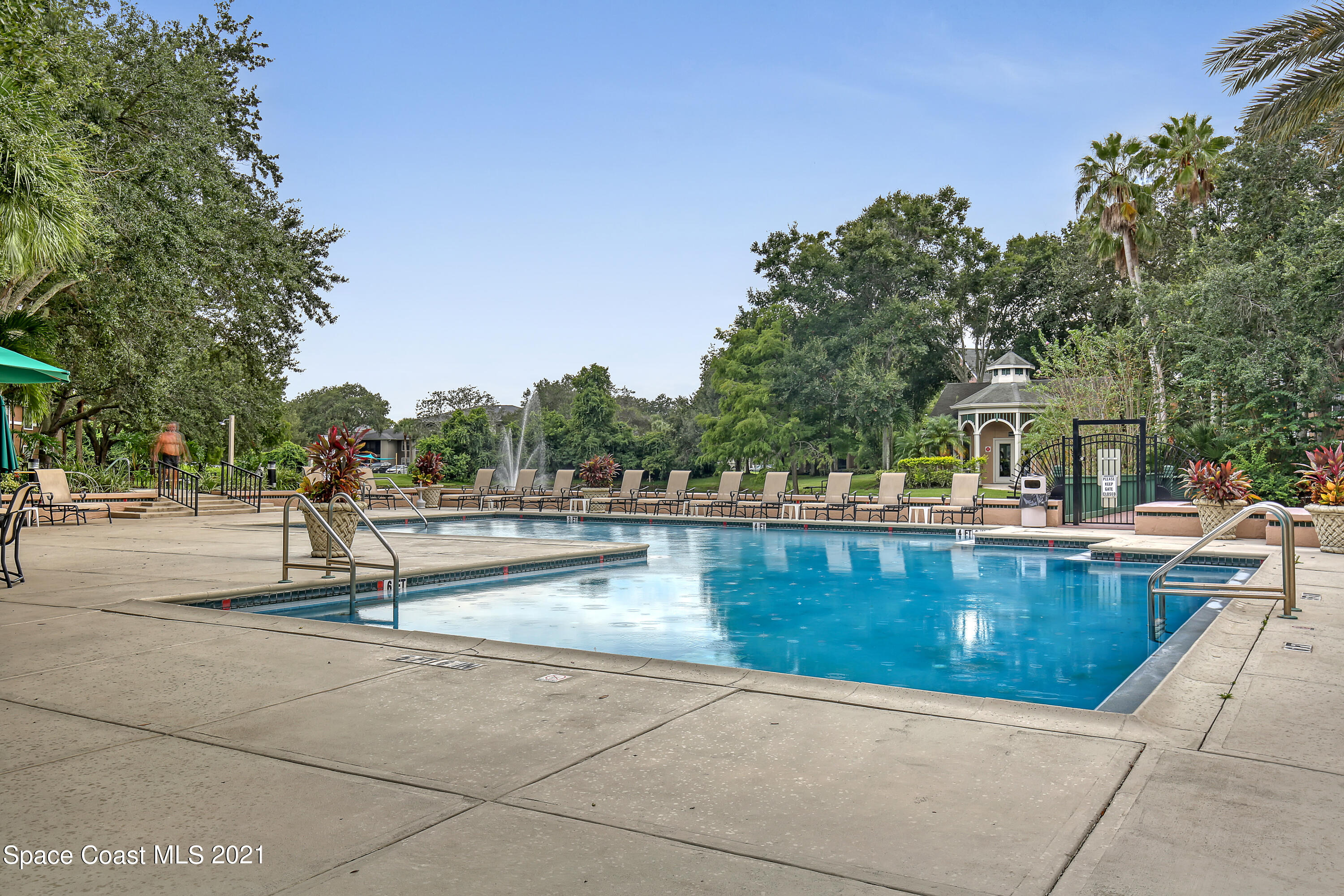 7667 North Wickham Road, Unit 804 Melbourne, FL 32940 - Photo 22 of 36 a view of swimming pool with outdoor seating and trees in the background