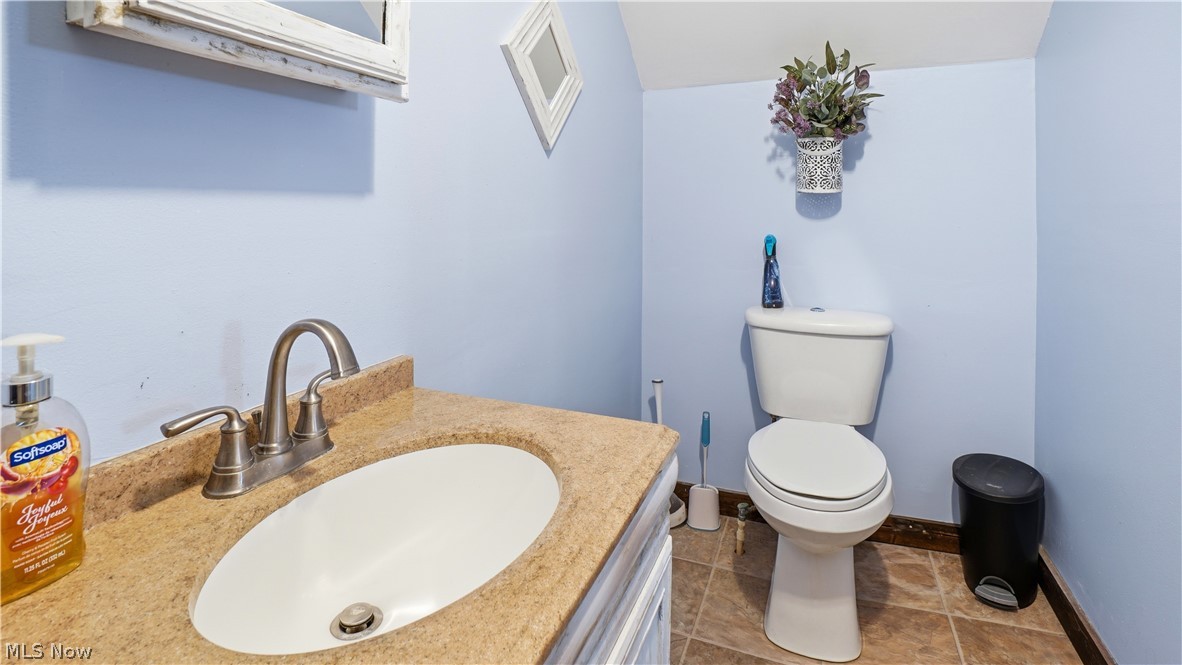 65892 Endley Road Cambridge, OH 43725 - Photo 39 of 50 Half bath featuring vanity and light tile patterned flooring