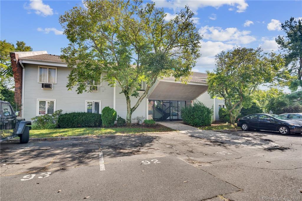 107 Florence Road, Unit 2A Branford, CT 06405 - Photo 1 of 1 a front view of a house with a yard and a garage