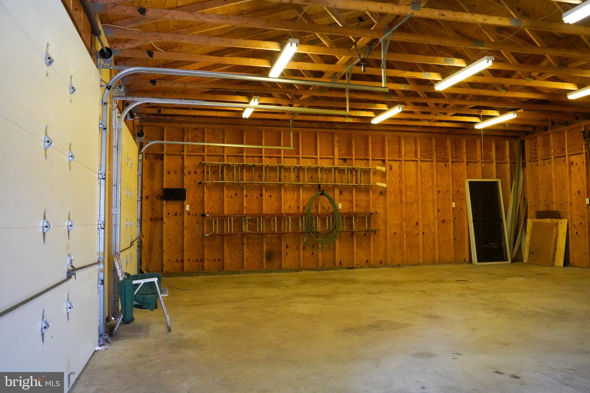 7323 O'Keefe Road Bealeton, VA 22712 - Photo 40 of 48 Spacious garage with rustic wooden walls.