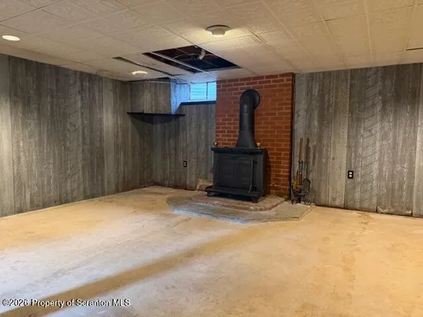 a view of an empty room with wooden walls