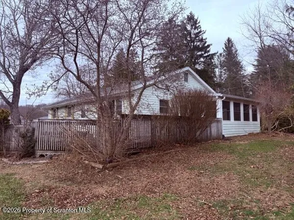 a house that has a tree in front of it