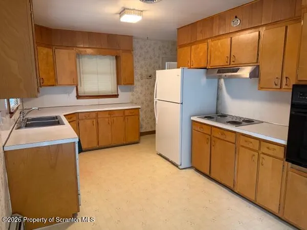 a kitchen with stainless steel appliances granite countertop a refrigerator a stove and a sink