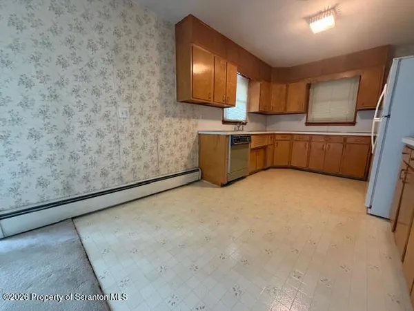 a kitchen with stainless steel appliances a refrigerator a sink a stove a microwave and cabinets