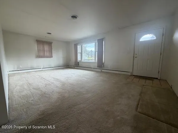 a view of an empty room with a window