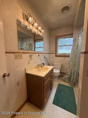 a bathroom with a sink toilet and mirror