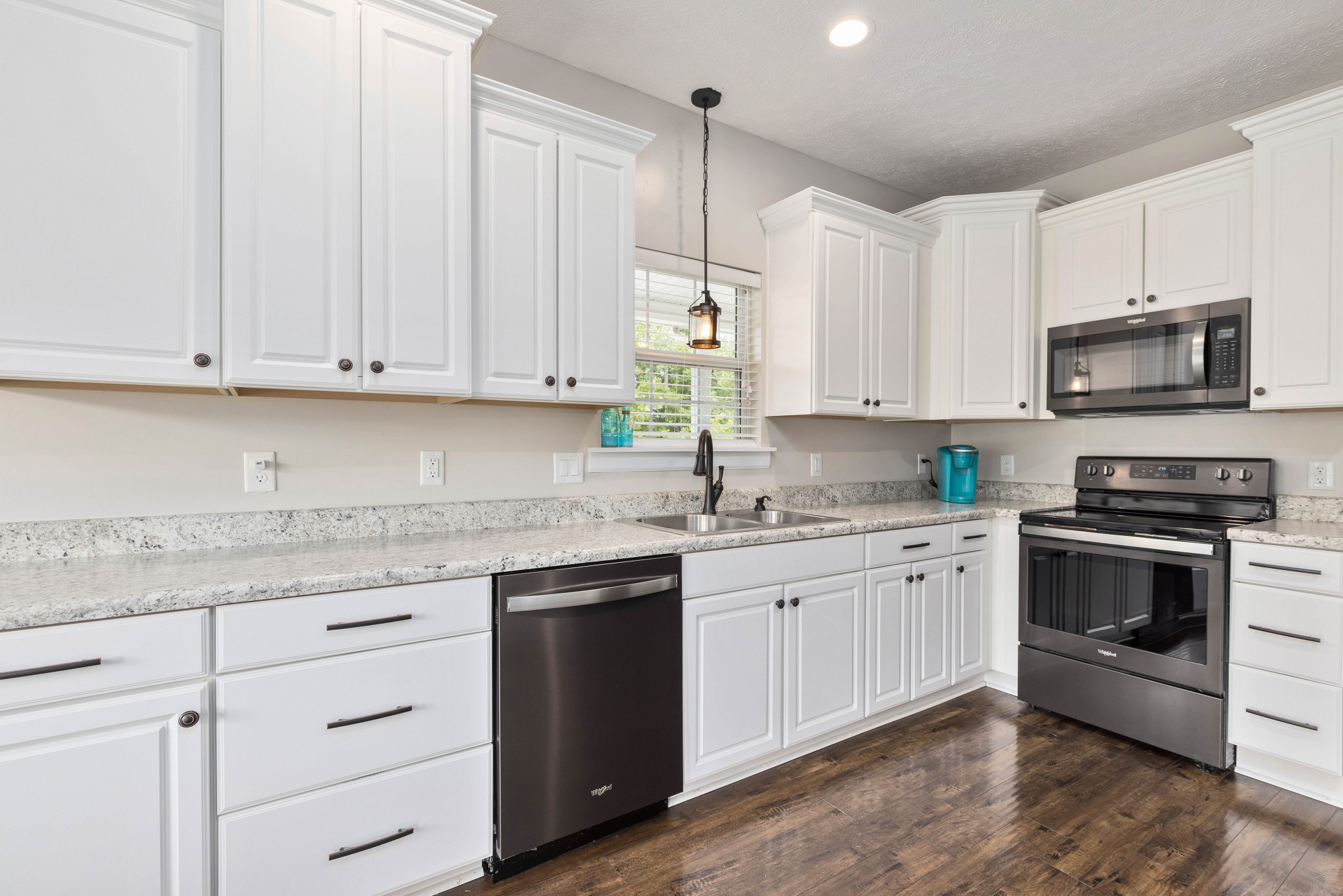7050 Williams Road Cross Plains, TN 37049 - Photo 48 of 50 a kitchen with granite countertop white cabinets and stainless steel appliances