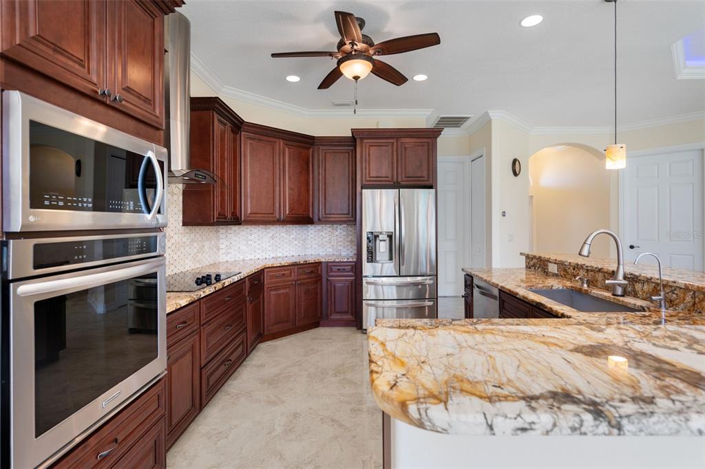 1900 Colleen Street Sarasota, FL 34231 - Photo 14 of 49 a kitchen with stainless steel appliances a stove a sink and a refrigerator