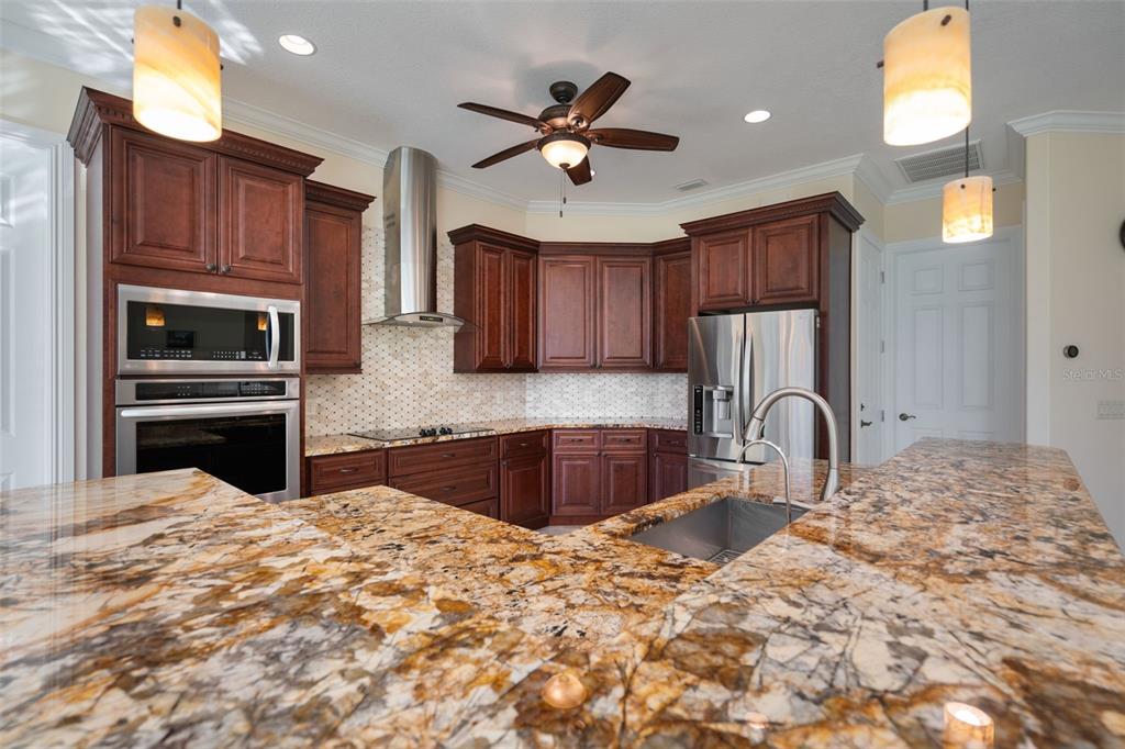 1900 Colleen Street Sarasota, FL 34231 - Photo 16 of 49 a kitchen with granite countertop a stove a sink and a microwave