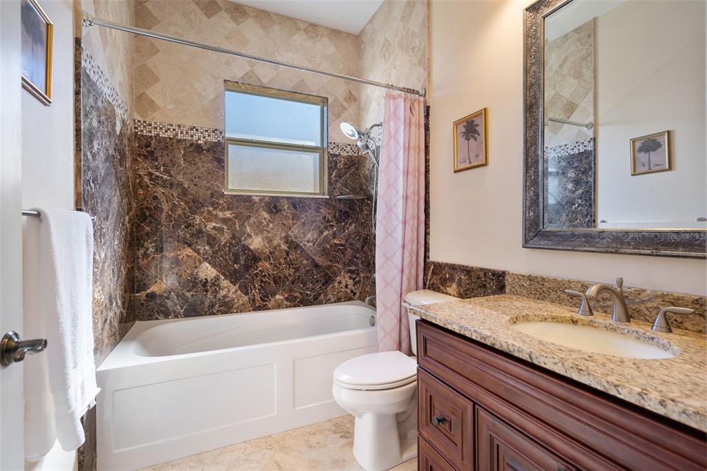 1900 Colleen Street Sarasota, FL 34231 - Photo 32 of 49 a bathroom with a granite countertop toilet sink and bathtub