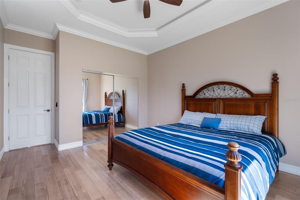 1900 Colleen Street Sarasota, FL 34231 - Photo 35 of 49 a bedroom with a bed and a chandelier