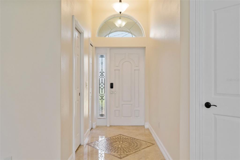 1900 Colleen Street Sarasota, FL 34231 - Photo 7 of 49 a view of a hallway with wooden floor and a chandelier